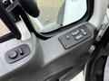 Interior view of a 2011 International WorkStar showing the driver's side control panel with window and mirror adjustment buttons