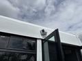 A 2020 Chevrolet Express with a partially open door and a mounted device on the roof