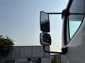 A 2016 Freightliner M2 106 truck with defined mirrors showing reflective surfaces and a sleek white exterior
