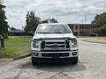 A 2017 Ford F-150 pickup truck is parked with its front view facing the camera showcasing the chrome grille and headlights