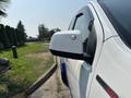 A white 2017 Chevrolet Colorado with a side mirror visible in the foreground displaying a chrome adjustment knob