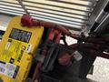 A yellow Optima battery with red cables and connectors visible, mounted in the engine compartment of a 2018 Grande West Vicinity vehicle