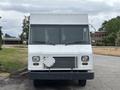 Front view of a 2018 Ford Econoline van with a boxy shape and a large windshield featuring headlights and a simple grille design