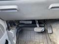 The interior of a 2007 Ford F-350 SD showing the floor with pedals including a brake pedal and a gas pedal