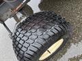 Close-up of a tire from a 2012 Kubota F3680 featuring a thick tread pattern and a gold rim