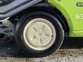 Close-up of a white wheel with a five-spoke design attached to a 2015 Tennant 636 Green Machine cleaning equipment