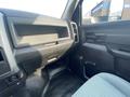 Interior view of a 2016 RAM 5500 featuring a dashboard with storage compartments and controls on the driver's side