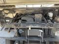 The image shows the engine compartment of a 2012 Ford Econoline with visible components such as wires hoses and a metal frame