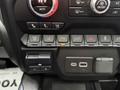 A 2022 GMC Sierra 3500HD dashboard controls featuring buttons for climate settings, exhaust brake, parking assistance, hazard lights, and USB ports