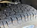 Tread of a tire from a 2022 GMC Sierra 1500 showing deep grooves and pronounced patterns for traction