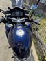 A 2016 Yamaha FJR1300AE motorcycle featuring a black and blue glossy body a fuel tank with a circular cap and a digital display on the handlebars