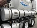 A silver 2013 International Workstar 7500 truck with a large, cylindrical tank attached to its side featuring black straps and a black frame