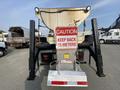 A 2016 RAM 5500 equipped with a large dump truck bed and a caution sign that reads KEEP BACK 15 METERS