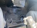 The interior of a 2011 Chevrolet Express featuring a floor-mounted support pole and a control panel area with a missing stereo unit