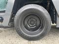 A black tire mounted on a metal rim labeled with the size 225 55 12 and the brand name Loadstar