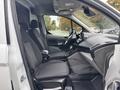 Interior view of a 2019 Ford Transit Connect showcasing the driver's seat and dashboard with a clean gray design and ergonomic layout