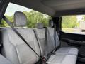 Interior view of the back seat of a 2021 Ford F-150 with gray cloth upholstery and seat belts visible