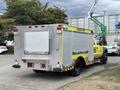A 2010 Ford F-550 Super Duty fire truck with a yellow and silver exterior featuring reflective stripes and a diamond plate toolbox on the rear