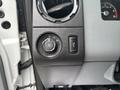Close-up of the control panel of a 2014 Ford F-550 featuring the headlight switch and interior lighting control