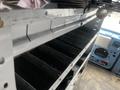 A 2009 Ford Econoline interior showcasing metal shelving units with several compartments for storage