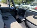 Interior view of a 2011 International 4300 featuring a driver’s seat, dashboard with controls, and a gear shifter