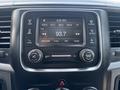 Dashboard display of a 2013 RAM 2500 showing radio settings with FM station tuned to 93.7 and the time displayed as 4:50 AM