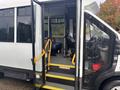A 2021 Ford Transit-350 with the doors open showing the driver's seat and steps leading up into the vehicle