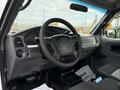 A 2011 Ford Ranger showcasing a black interior with a steering wheel and dashboard features visible
