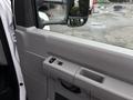 The interior door panel of a 2017 Ford Econoline featuring window controls and a textured panel