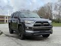 A black 2021 Toyota 4Runner is parked, showcasing its bold front grille, sleek design, and alloy wheels