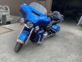 A blue 2017 Harley-Davidson FLHTKL motorcycle with a large front fairing and comfortable seating for two