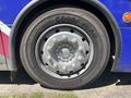 A close-up view of a tire mounted on a rim branded with Good Year and featuring multiple lug nut openings