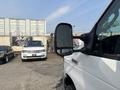 A 2008 Ford Econoline van is in the foreground with its side mirror prominently visible