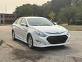 A 2015 Hyundai Sonata in white with a sleek design featuring a distinctive grille and modern headlights