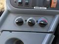 The image shows the control panel of a 2009 International 3000 CE bus with knobs for air control heat and temperature settings