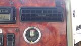 Dashboard of a 2003 International 5600i featuring a visible air filter monitor and various control switches