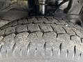 Close-up of a worn tire tread from a 2020 Ford Transit 250 showing deep grooves and uneven wear