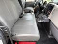 Interior of a 2012 International TerraStar with gray leather seats and a central console featuring controls and cup holder