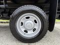 Close-up of a white wheel and tire from a 2015 Ford F-350 SD showcasing the tread pattern and hubcap design