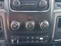 Dashboard controls of a 2013 RAM 5500 featuring climate control knobs buttons for hazard lights and various function switches