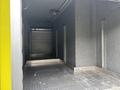 Interior view of a truck with a metallic floor and lined walls showing a roller shutter at the back