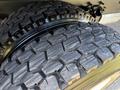 Close-up view of two heavy-duty tires with deep treads designed for a 2017 Ford F-650 Super Duty truck