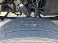 Close-up of a worn tire tread from a 2005 GMC C7500 Topkick showing uneven wear and visible markings on the sidewalls