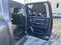 A 2017 RAM 1500 with the driver's side door open showing the interior and seats
