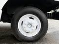 Close-up of a white wheel on a 2012 Ford Econoline with a black tire and visible lug nuts