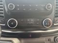 Interior control panel of a 2021 Ford Transit-350 featuring climate control buttons audio controls and a digital display