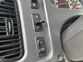 Close-up of the dashboard controls of a 2013 Freightliner 114SD showing various buttons for lighting and adjustments