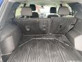A 2022 Chevrolet Equinox with folded rear seats revealing a spacious cargo area lined with a rubber mat