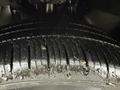 A close-up view of a wet tire tread showing deep grooves and a rugged surface designed for traction on a 2017 RAM ProMaster City