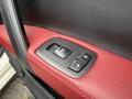 A close-up view of a 2016 Maserati Ghibli door panel with red leather trim featuring the window and door lock control buttons